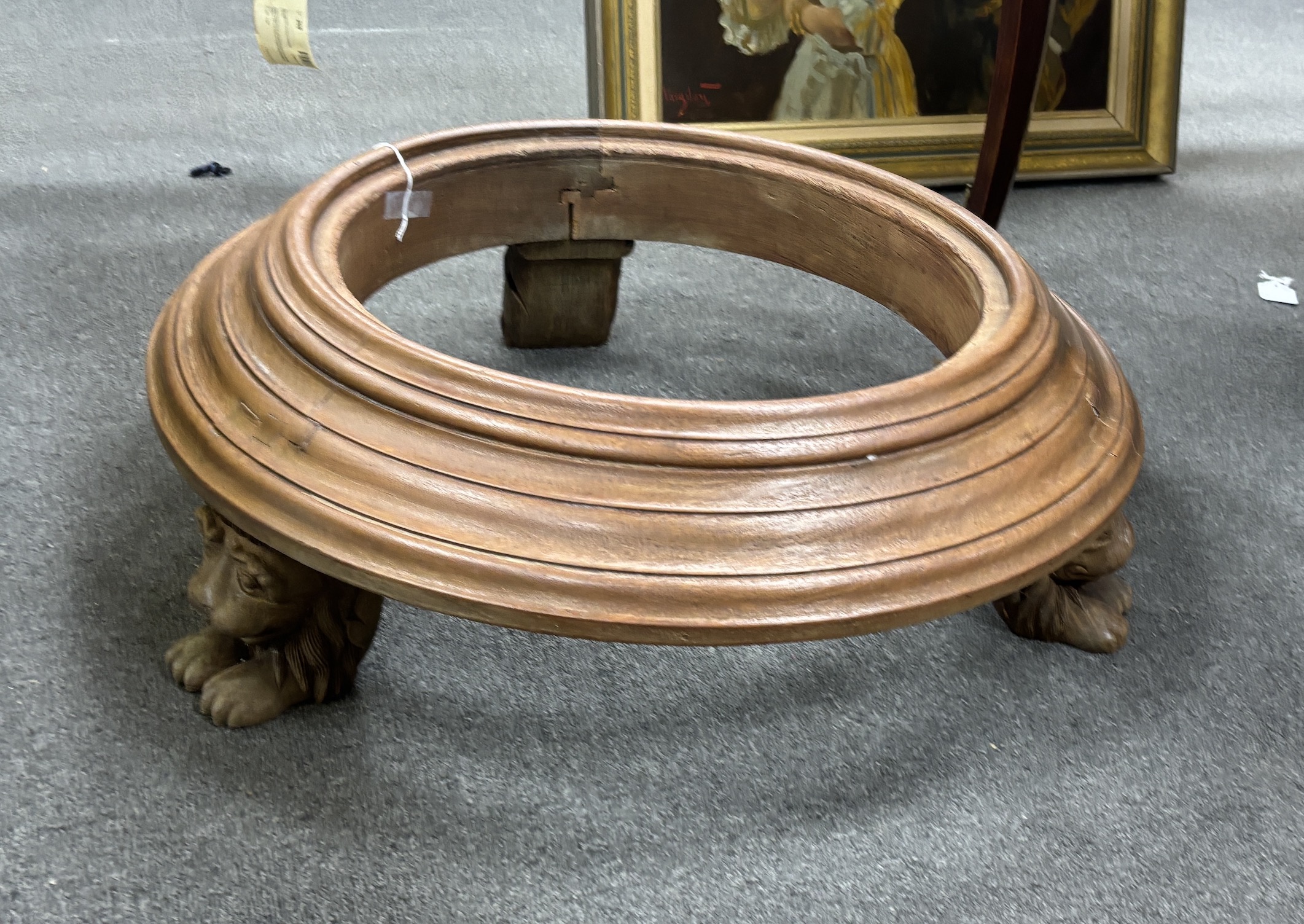 An Indonesian hardwood stand, lion head supports, diameter 67cm